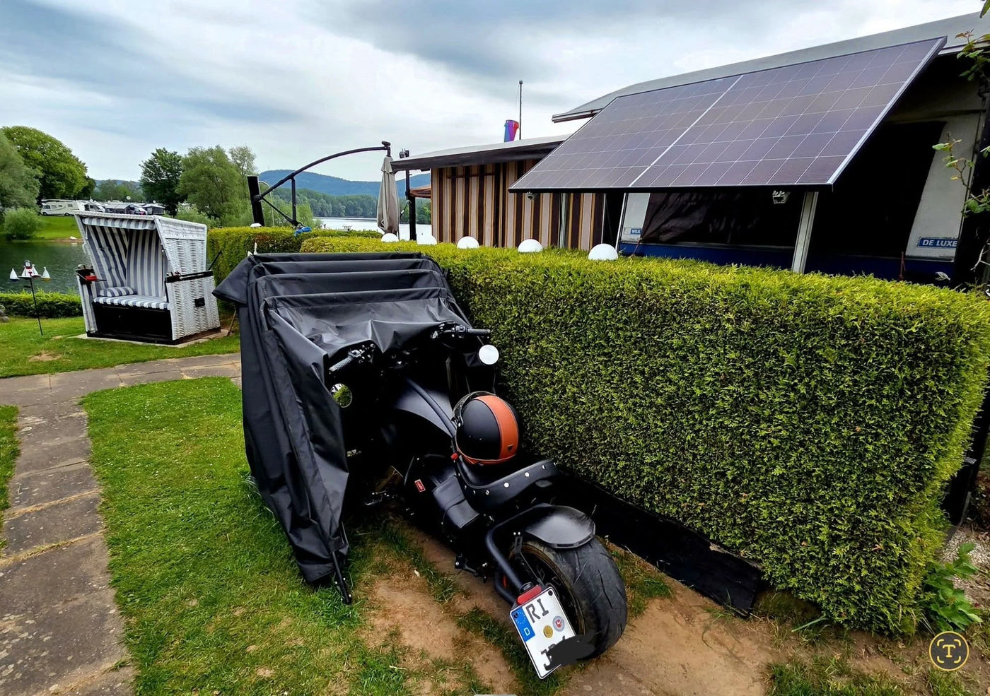 A P210 reliably charges an electric scooter on a long-term camping site.